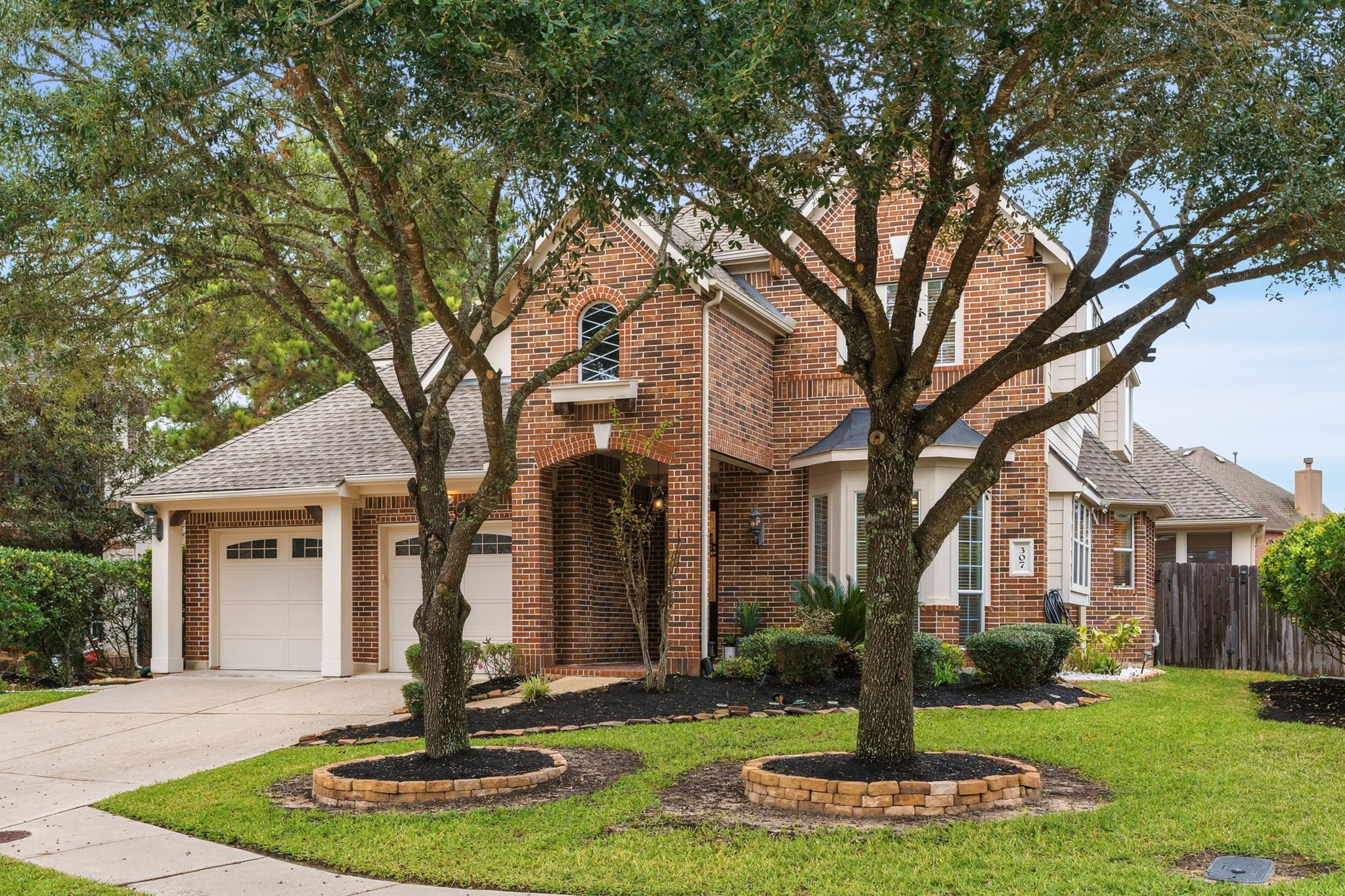 307 Arbor Ridge Lane Conroe, TX 77384 - Photo 3 of 50 a front view of a house with a yard and palm trees