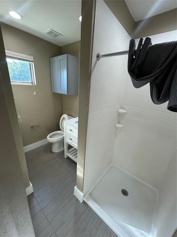 301 East Brockett Street Sherman, TX 75090 - Photo 12 of 14 a bathroom with a shower and a toilet