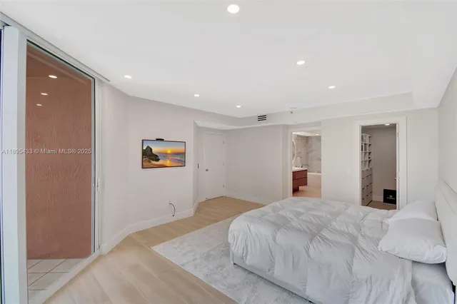 a bathroom with a glass shower door and mirror