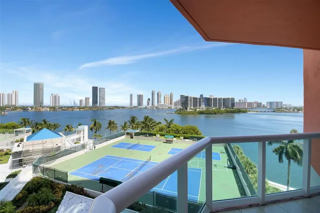 a view of a kitchen with stainless steel appliances kitchen island granite countertop a sink and cabinets