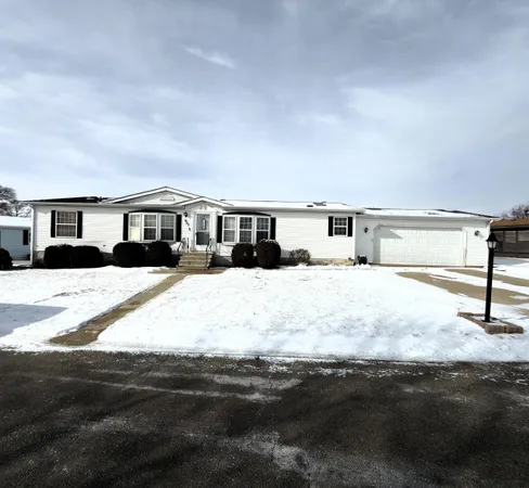 a view of house with yard and sitting area