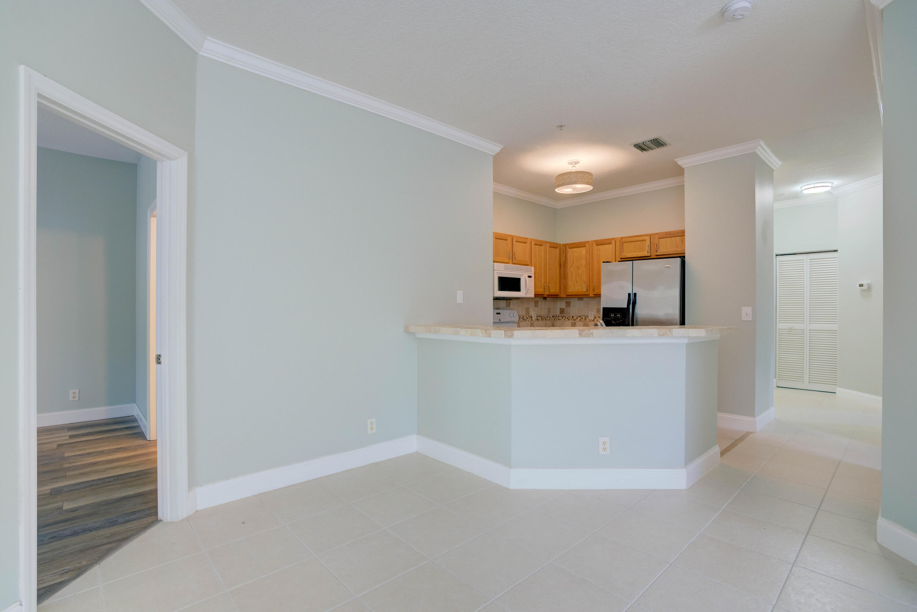 115 Lighthouse Circle, Unit B Tequesta, FL 33469 - Photo 23 of 42 a view of a kitchen and an entryway