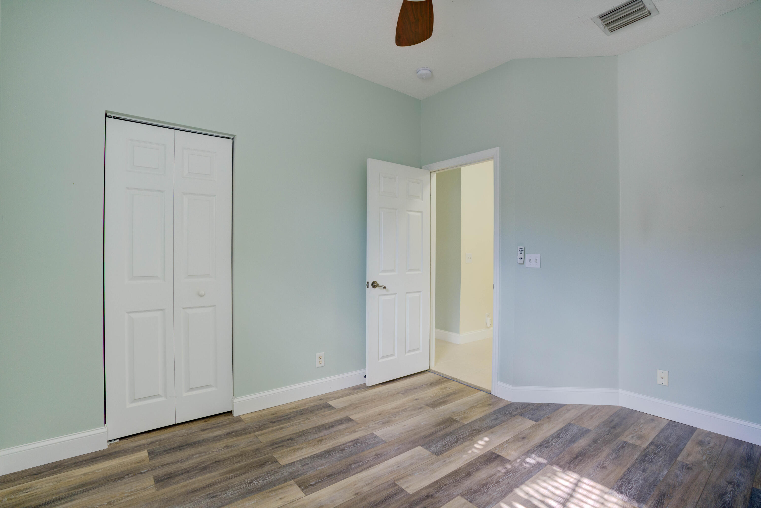 115 Lighthouse Circle, Unit B Tequesta, FL 33469 - Photo 30 of 42 a view of an empty room with wooden floor