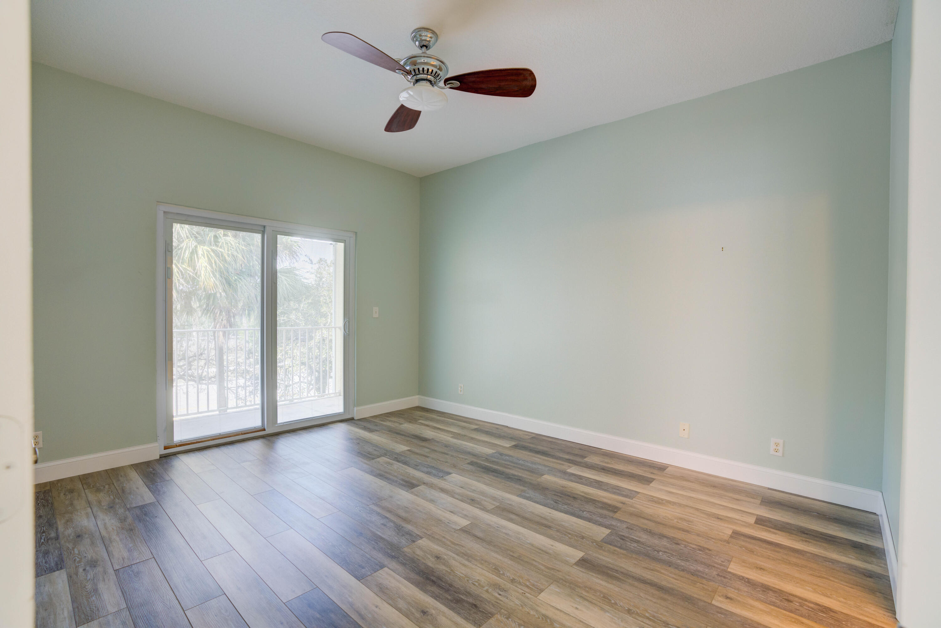 115 Lighthouse Circle, Unit B Tequesta, FL 33469 - Photo 36 of 42 an empty room with wooden floor and windows
