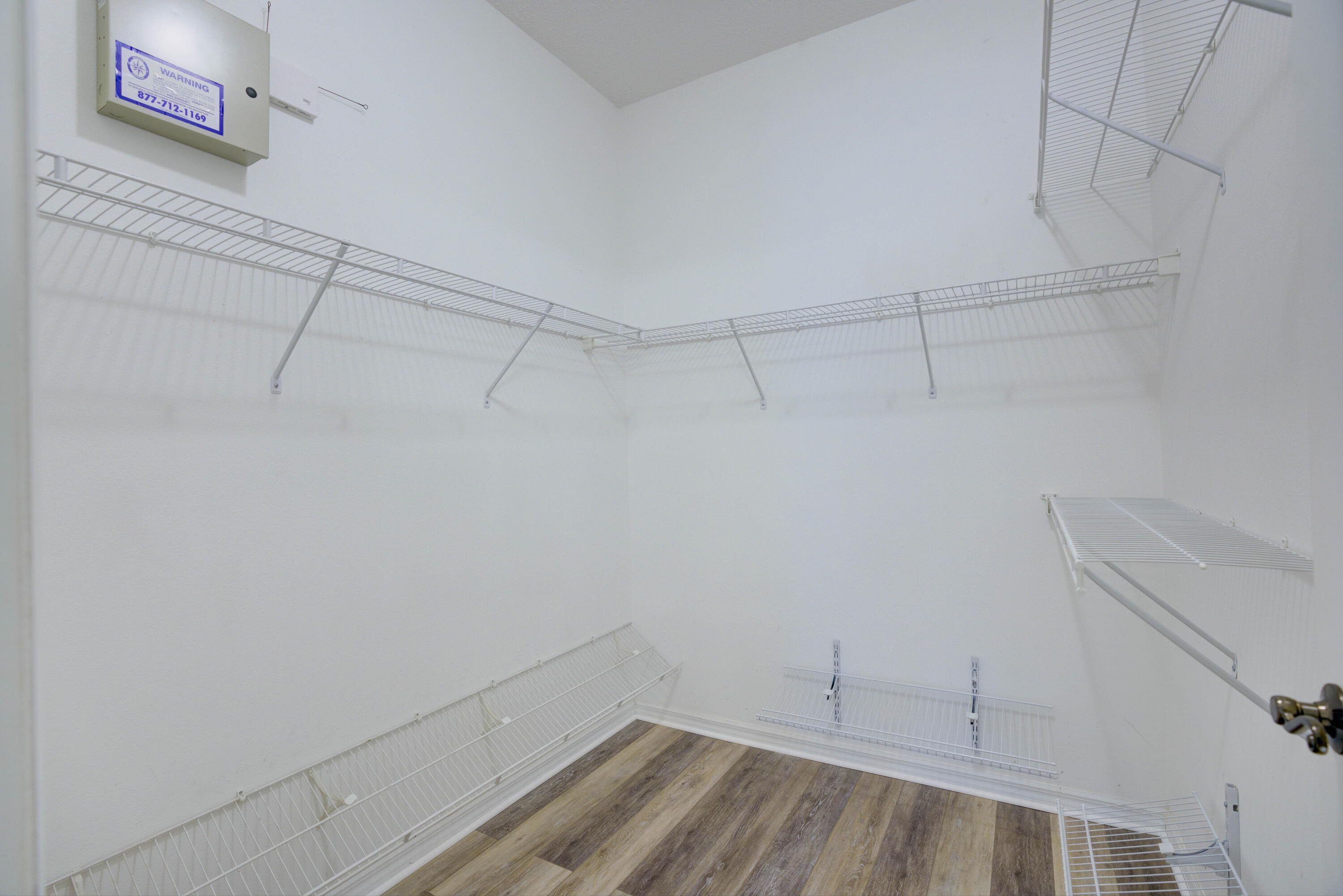 115 Lighthouse Circle, Unit B Tequesta, FL 33469 - Photo 42 of 42 a view of a room with racks on the wall