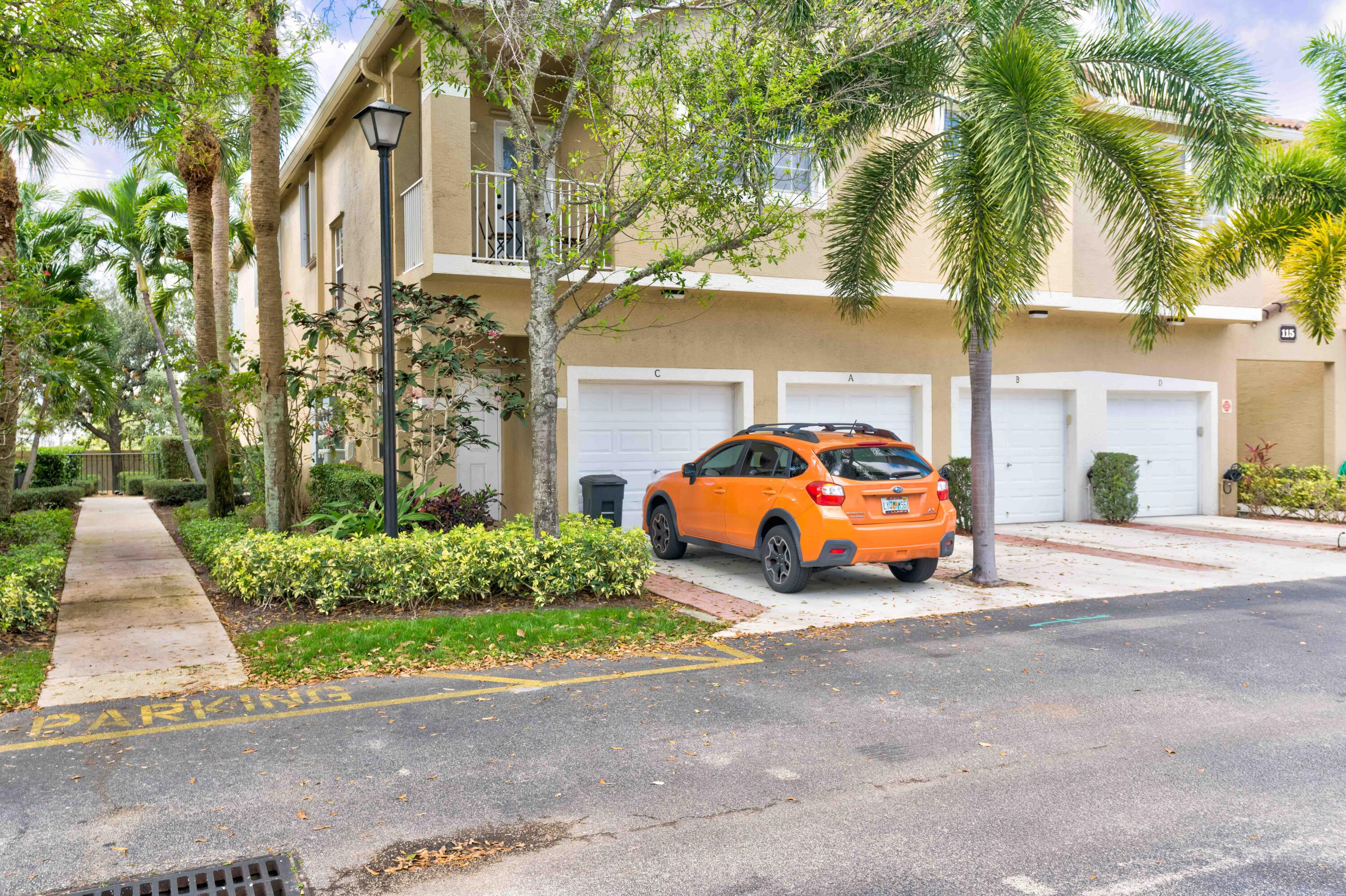 115 Lighthouse Circle, Unit B Tequesta, FL 33469 - Photo 8 of 42 a car parked in front of a white house