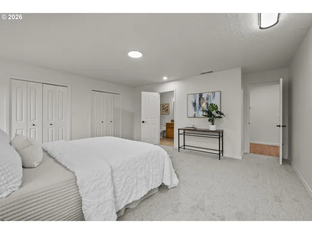 a bedroom with a bed and a table