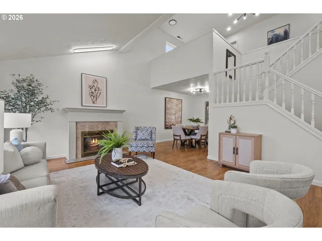 a living room with furniture a fireplace and a table