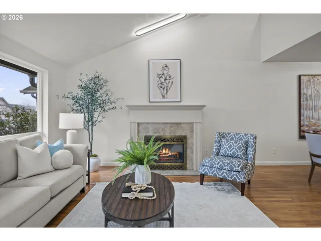 a living room with furniture a chandelier and a fireplace