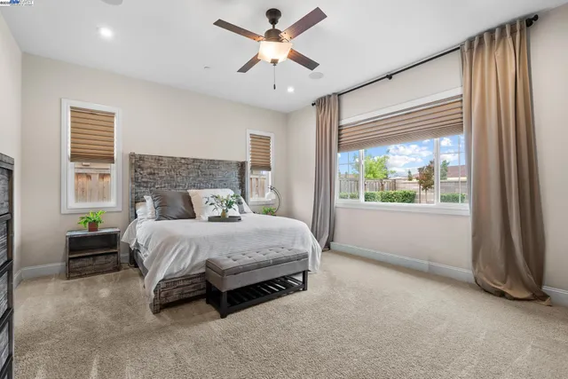 a spacious bedroom with a bed and a large window