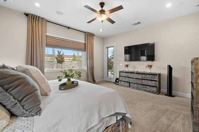a bedroom with a bed and flat screen tv