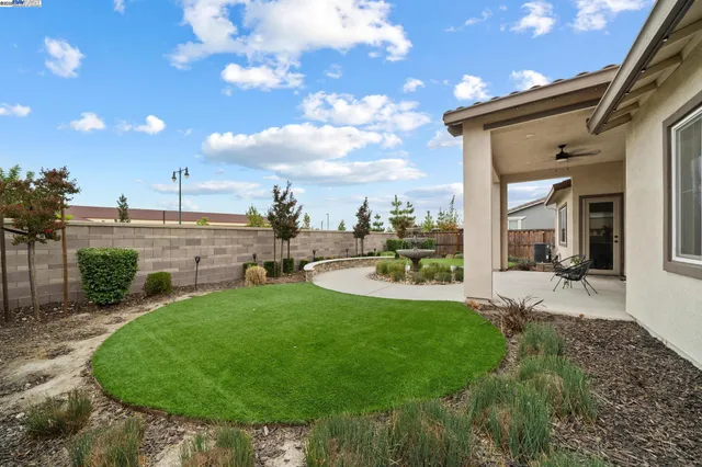 a view of a backyard with sitting area