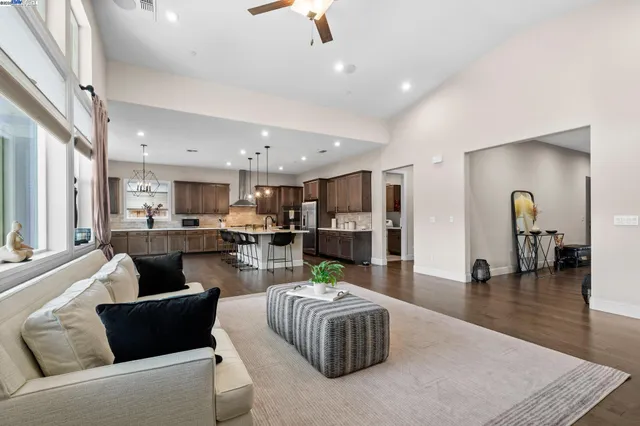 a living room with furniture and kitchen view
