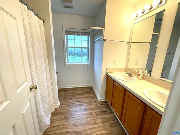 a view of a kitchen with a sink and wooden floor