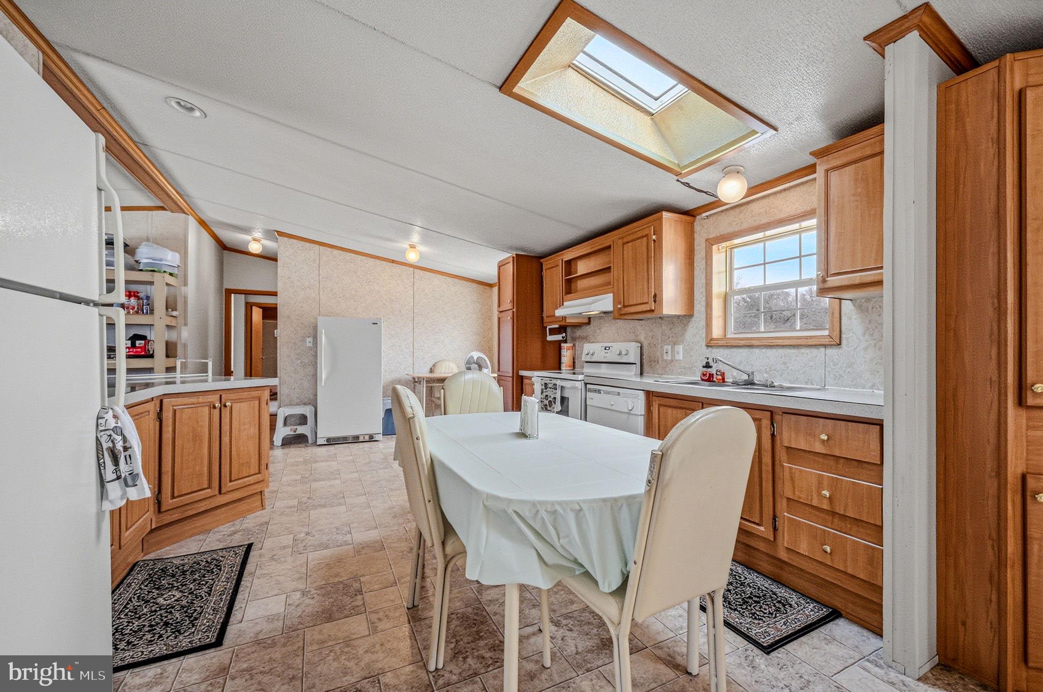 2237 Marshyhope Road Felton, DE 19943 - Photo 21 of 38 a dining room with furniture a rug and wooden floor