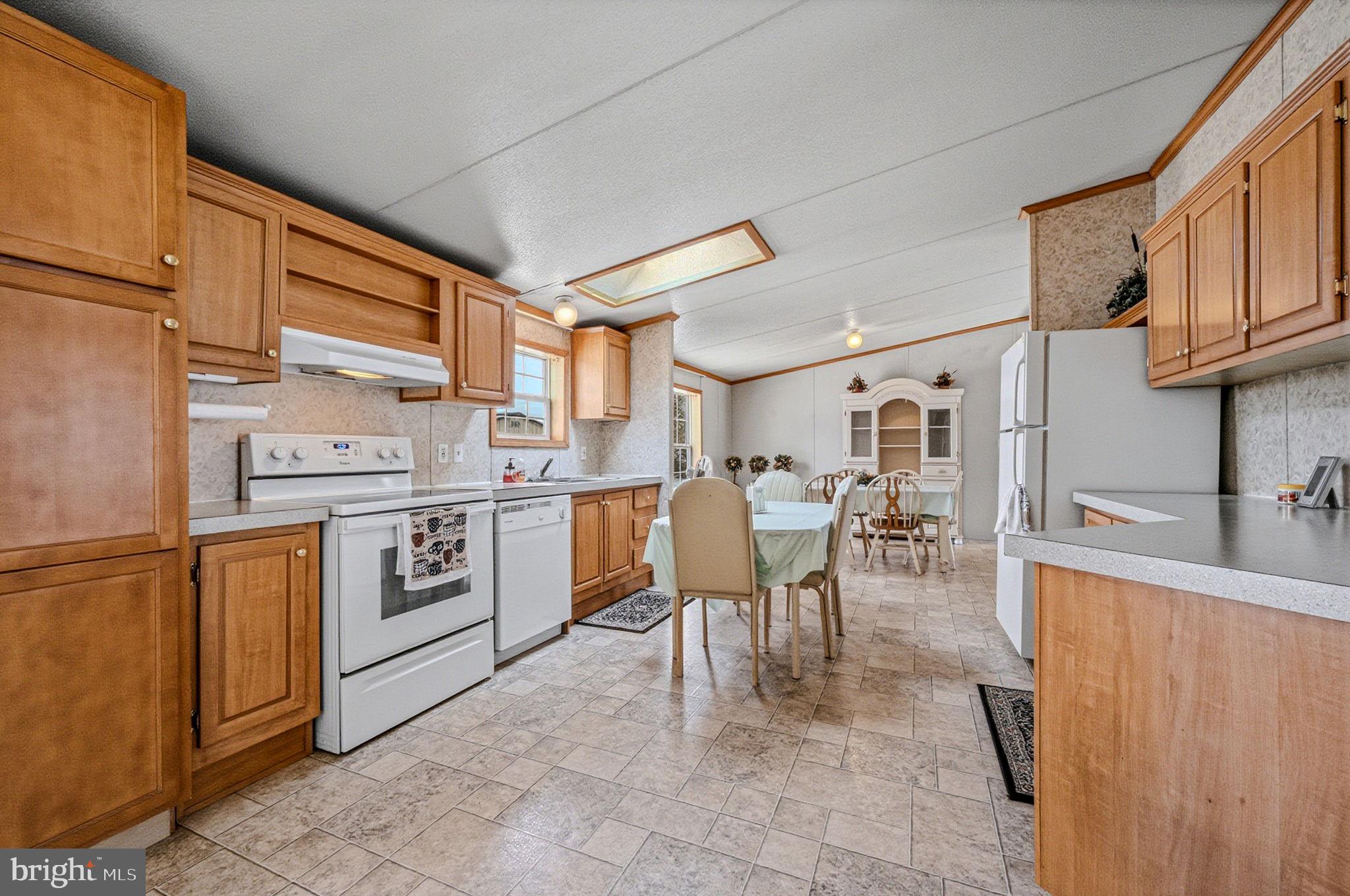 2237 Marshyhope Road Felton, DE 19943 - Photo 22 of 38 a kitchen with appliances cabinets table and chairs