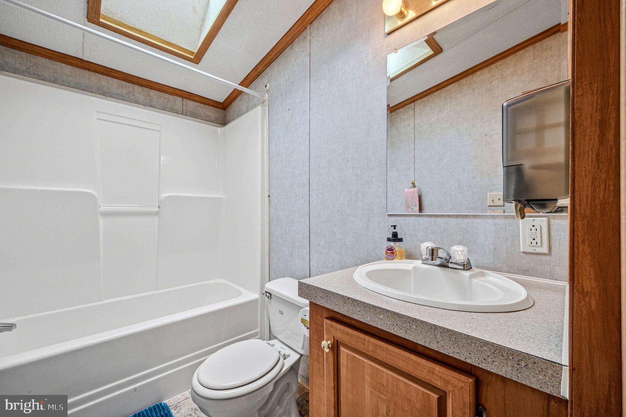 2237 Marshyhope Road Felton, DE 19943 - Photo 29 of 38 a bathroom with a sink toilet vanity and shower