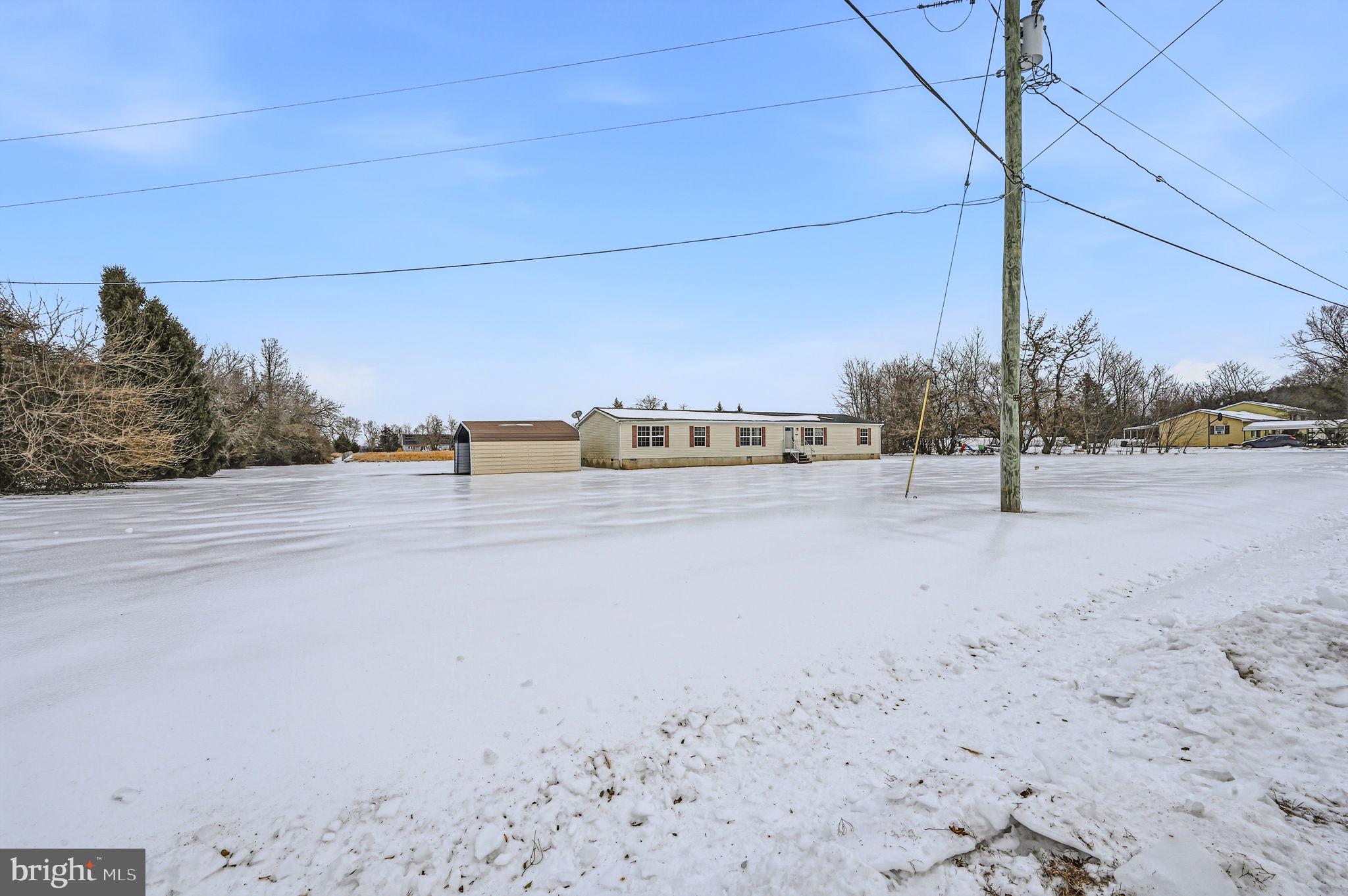 2237 Marshyhope Road Felton, DE 19943 - Photo 3 of 38 a view of a road with a building in the background