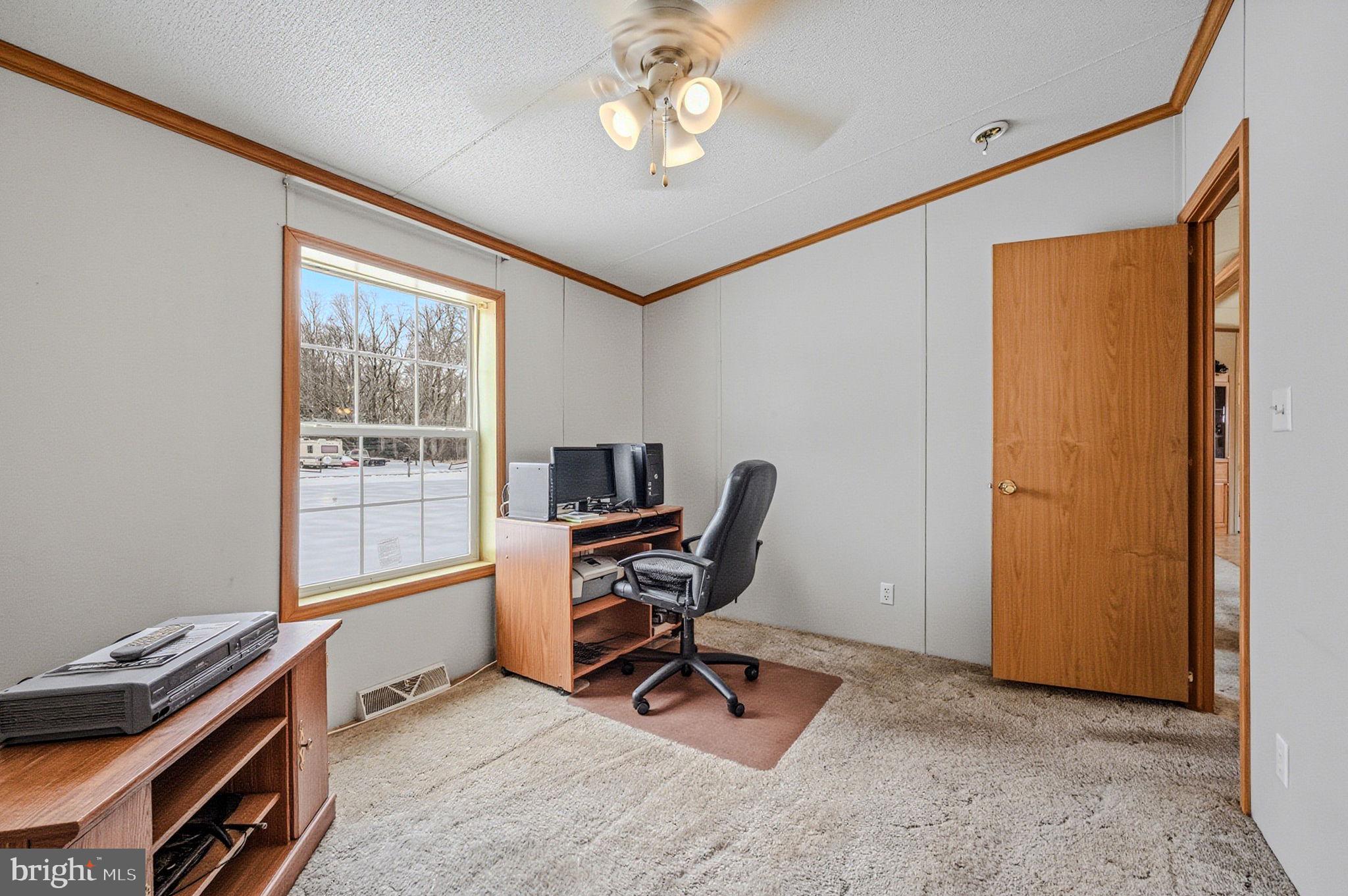 2237 Marshyhope Road Felton, DE 19943 - Photo 31 of 38 a view of a workspace with furniture and a window