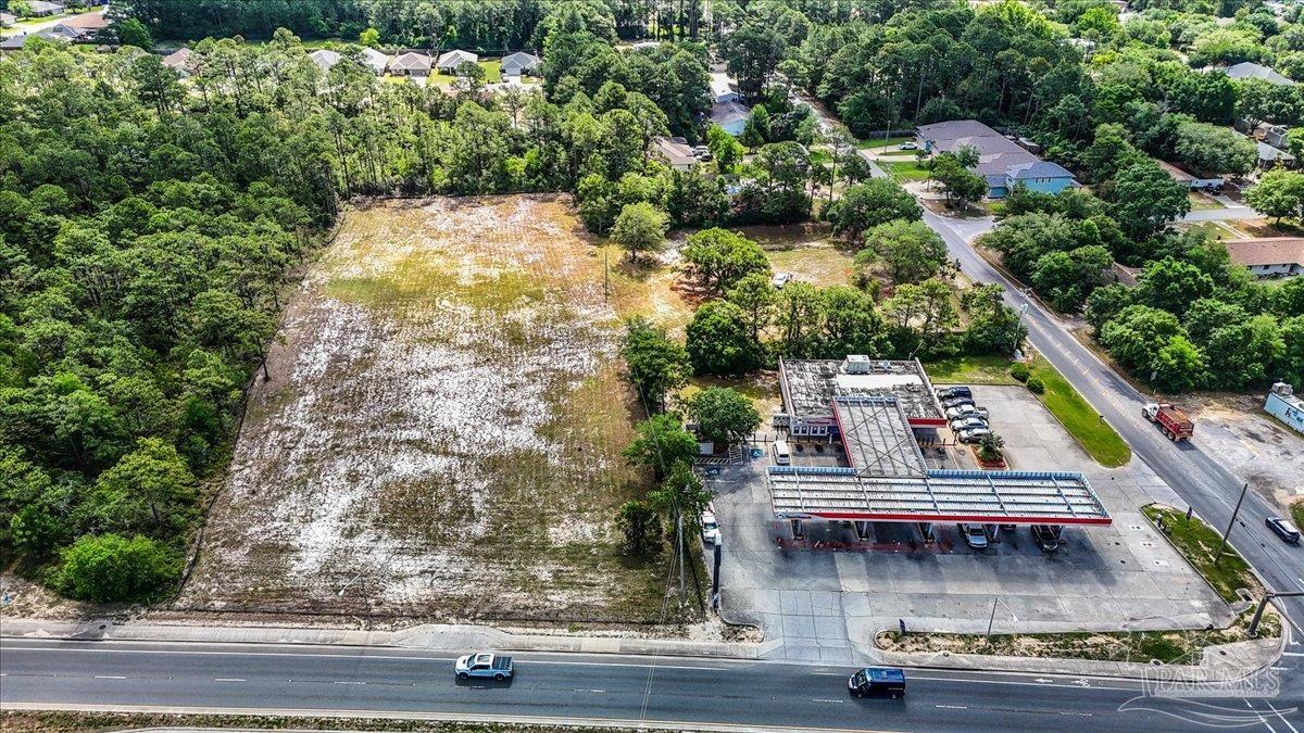 2032 Highway 87 Navarre, FL 32566 - Photo 3 of 11 an aerial view of a house with swimming pool and lake view