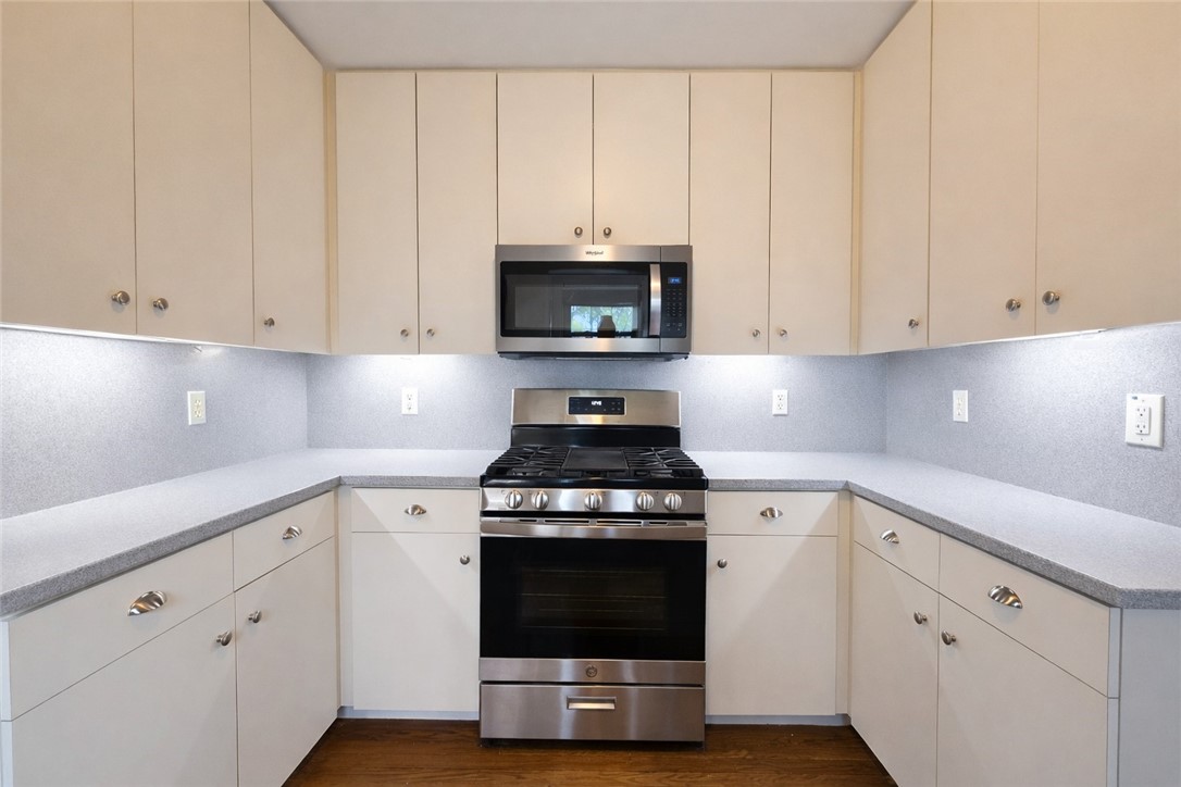 332 Southern Street Corpus Christi, TX 78404 - Photo 6 of 20 a kitchen with granite countertop white cabinets and stainless steel appliances