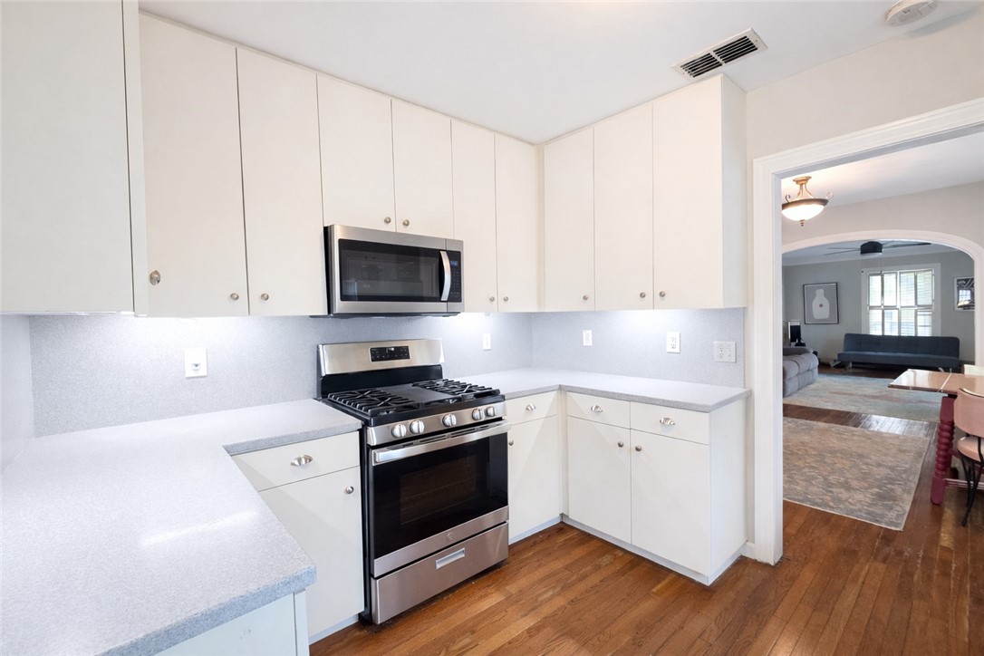 332 Southern Street Corpus Christi, TX 78404 - Photo 7 of 20 a kitchen with granite countertop white cabinets and white appliances