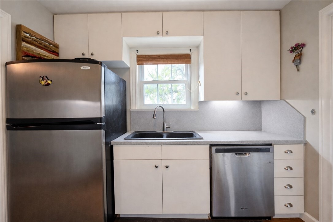 332 Southern Street Corpus Christi, TX 78404 - Photo 8 of 20 a kitchen with stainless steel appliances a refrigerator sink and cabinets