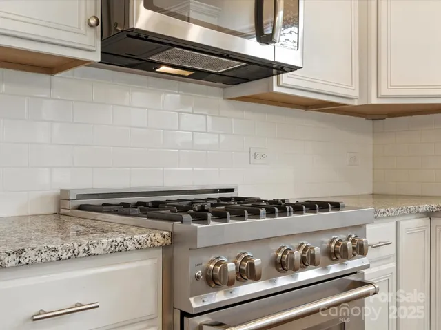 a white stove top oven sitting inside of a kitchen