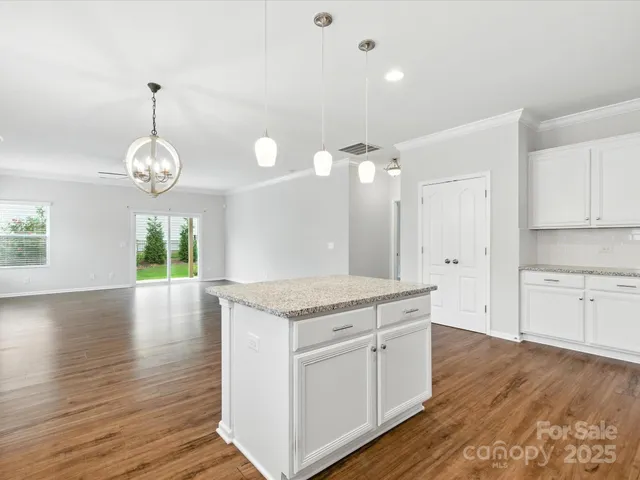 a kitchen with a wooden floor and window