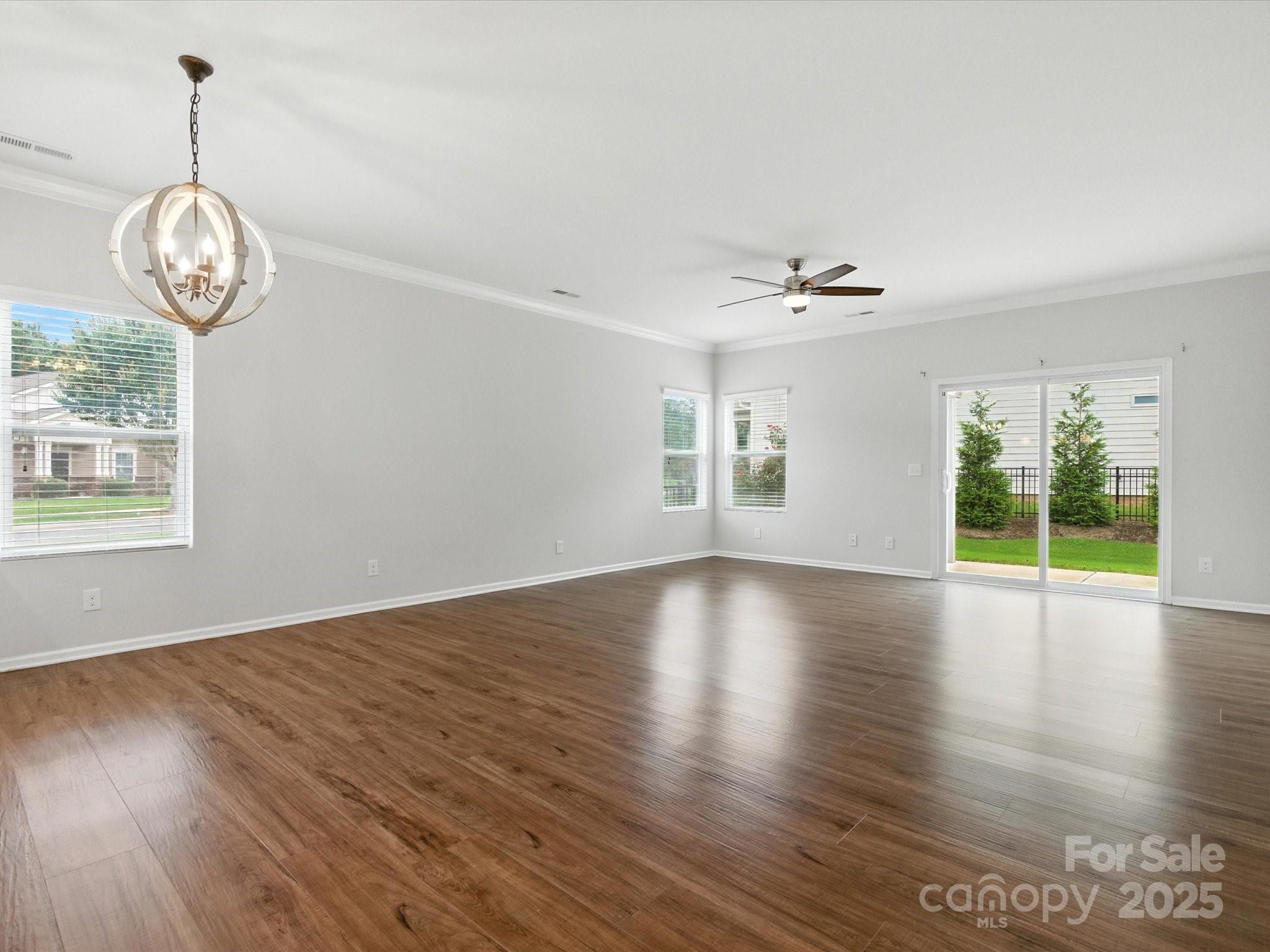 1628 Spring Blossom Trail Fort Mill, SC 29708 - Photo 18 of 42 a view of an empty room with wooden floor and a window