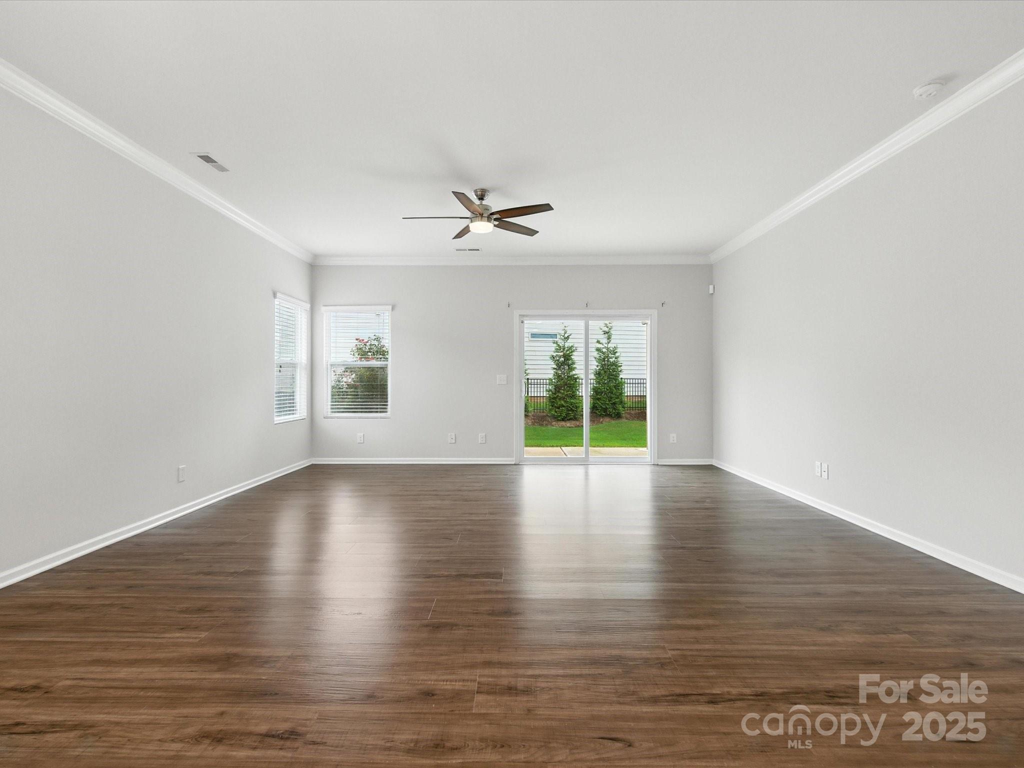1628 Spring Blossom Trail Fort Mill, SC 29708 - Photo 19 of 42 a view of empty room with wooden floor and fan