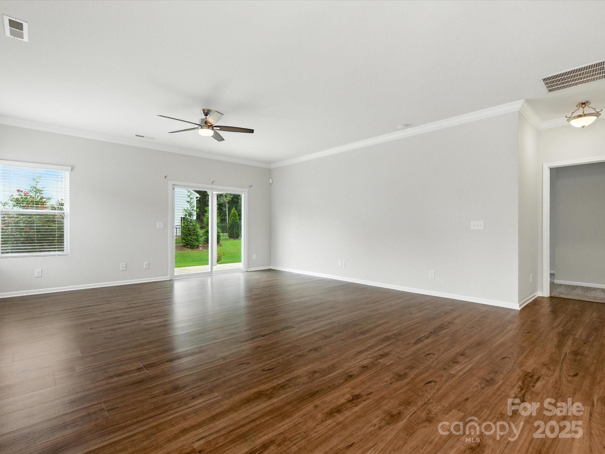 1628 Spring Blossom Trail Fort Mill, SC 29708 - Photo 20 of 42 a view of an empty room with wooden floor and a window