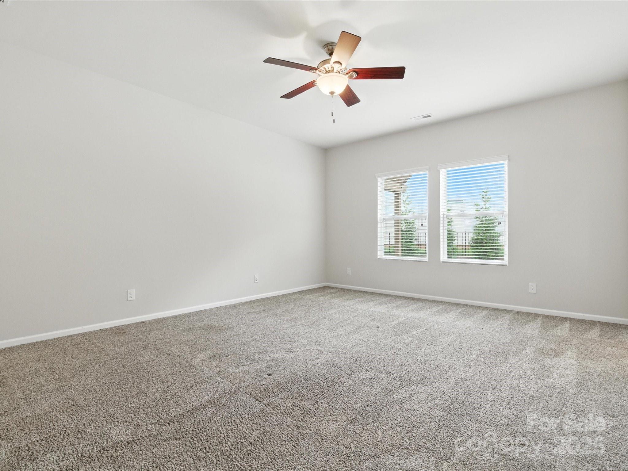 1628 Spring Blossom Trail Fort Mill, SC 29708 - Photo 22 of 42 an empty room with fan and windows
