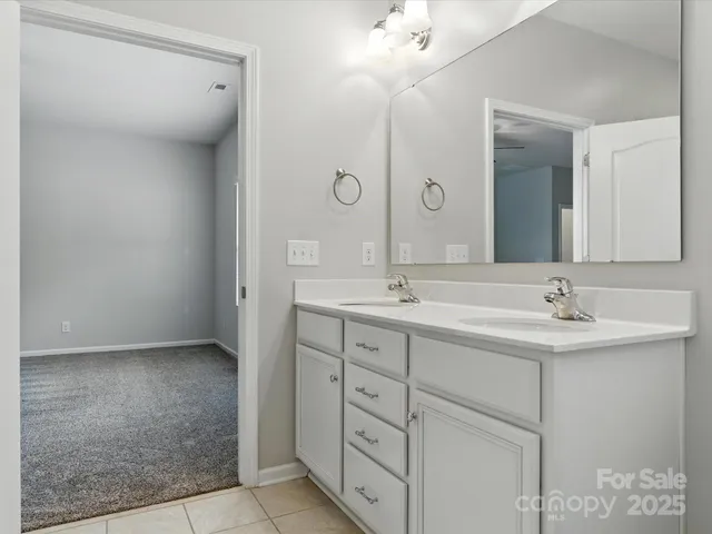 a bathroom with a double vanity sink and a mirror