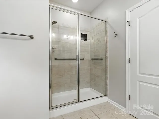a bathroom that has a glass shower door