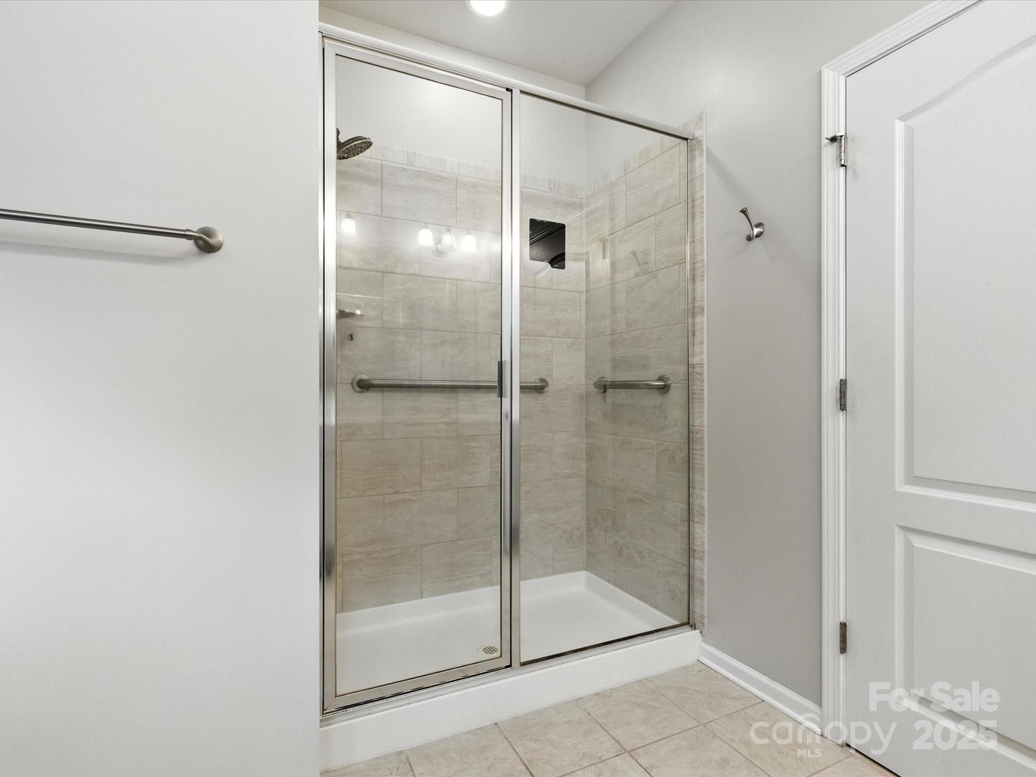 1628 Spring Blossom Trail Fort Mill, SC 29708 - Photo 27 of 42 a bathroom that has a glass shower door