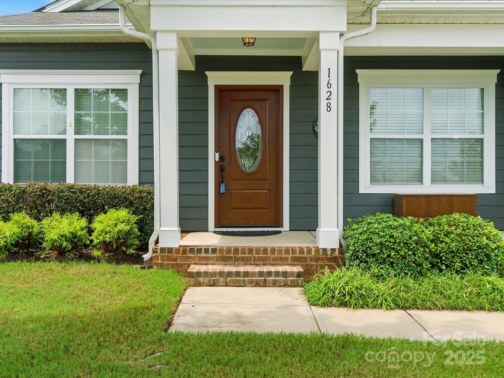 1628 Spring Blossom Trail Fort Mill, SC 29708 - Photo 3 of 42 a front view of a house with garden