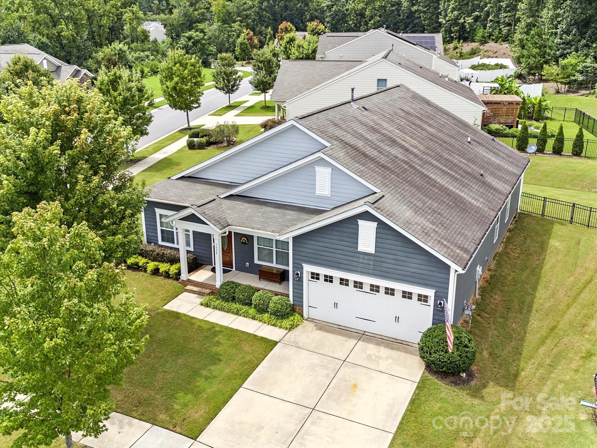 1628 Spring Blossom Trail Fort Mill, SC 29708 - Photo 39 of 42 a view of a house with a big yard and large trees