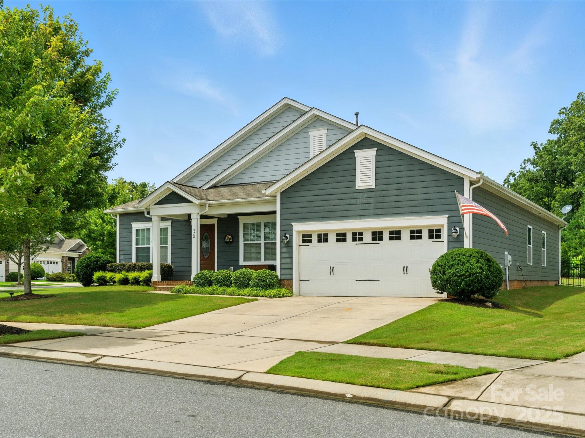 1628 Spring Blossom Trail Fort Mill, SC 29708 - Photo 40 of 42 a view of a house with a yard and large trees