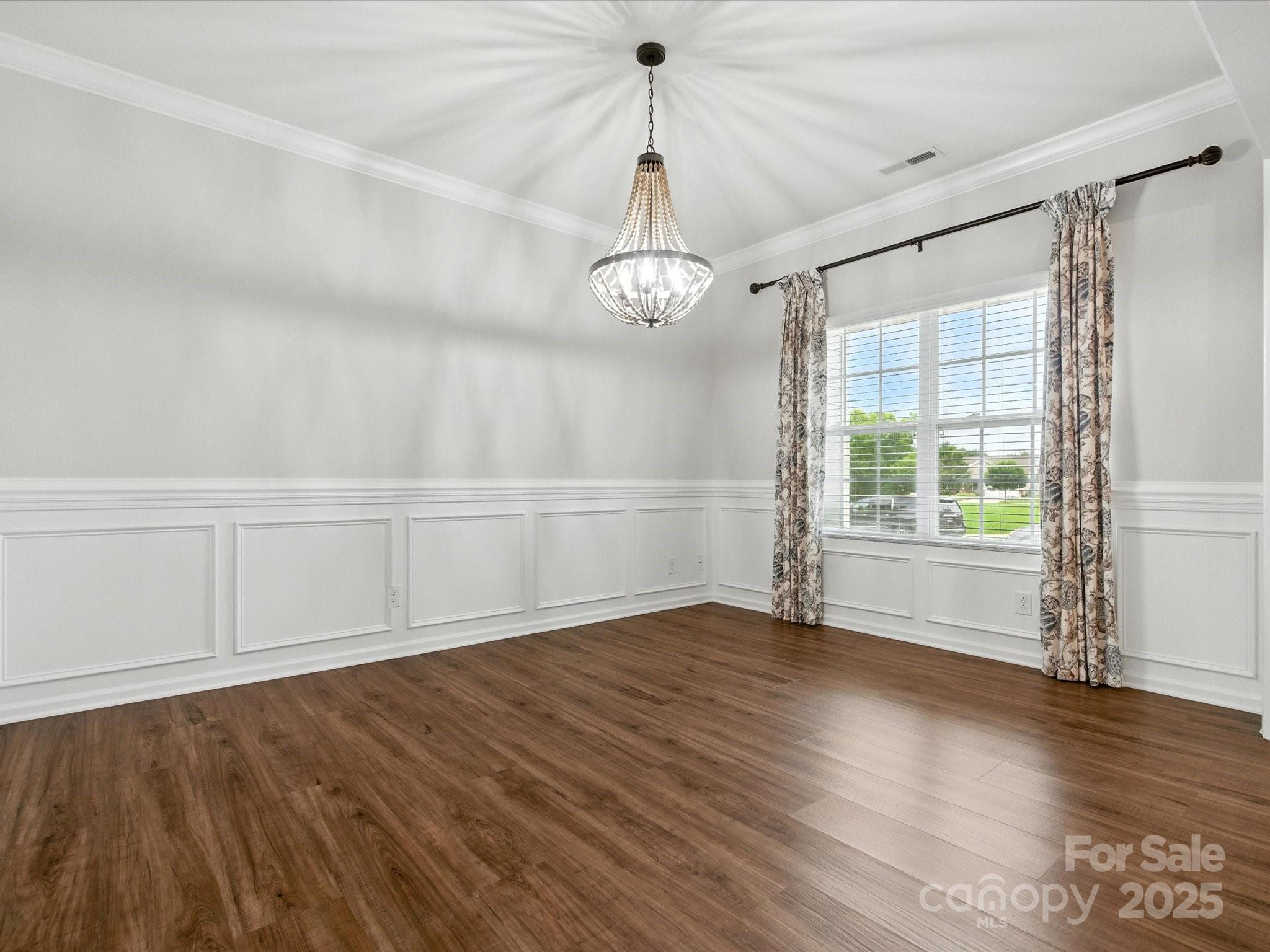 1628 Spring Blossom Trail Fort Mill, SC 29708 - Photo 6 of 42 a view of an empty room with wooden floor and a window