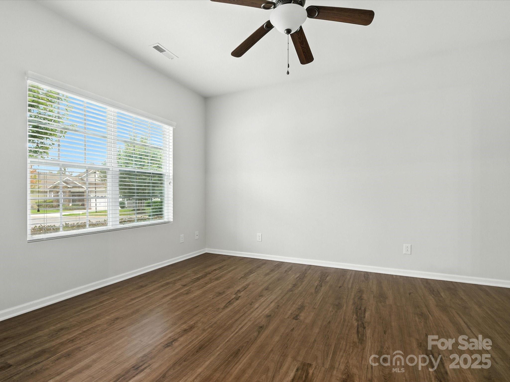 1628 Spring Blossom Trail Fort Mill, SC 29708 - Photo 7 of 42 a view of a room with wooden floor and windows