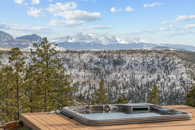 a view of a porch with a table and chairs
