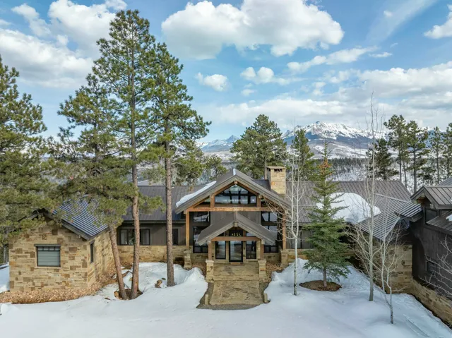 a house with green field in front of it