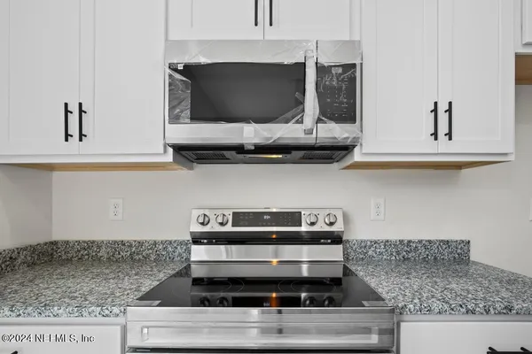 a bedroom with a large bed and a large window