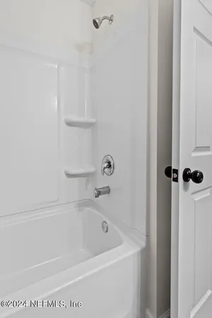 an empty room with wooden floor and ceiling fan