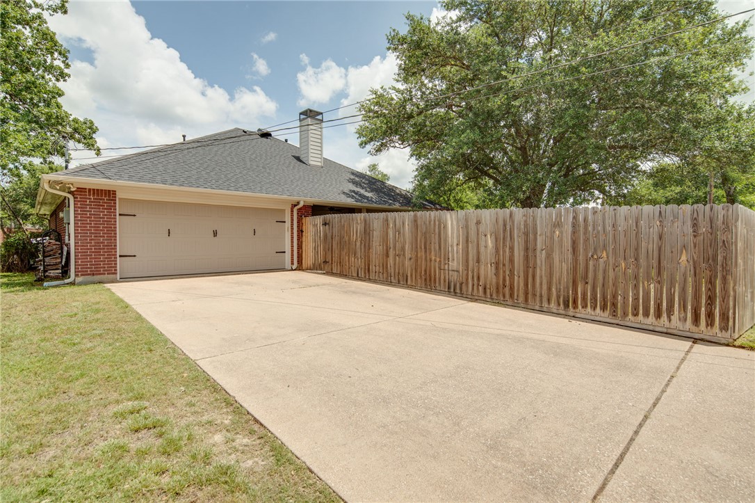4700 Kensington Road Bryan, TX 77802 - Photo 30 of 31 Concrete driveway leading to a two-car rear entry garage