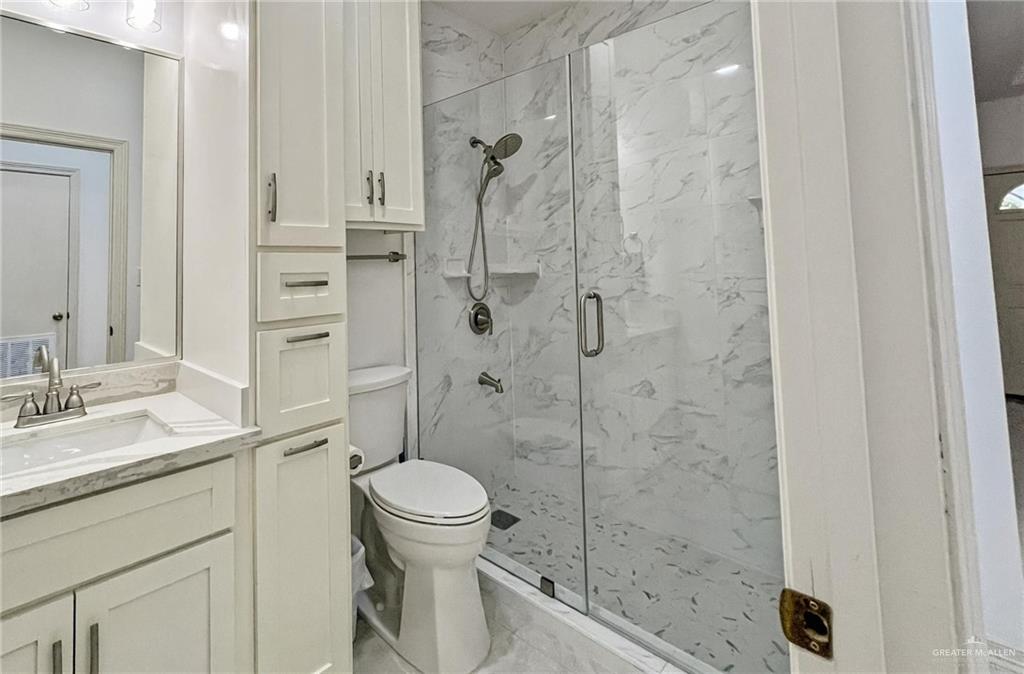 7723 Villa Rama S Street Mission, TX 78572 - Photo 12 of 15 a bathroom with a sink a toilet and shower