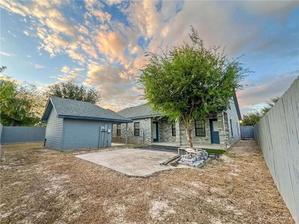 7723 Villa Rama S Street Mission, TX 78572 - Photo 15 of 15 a backyard of a house with table and chairs under an umbrella