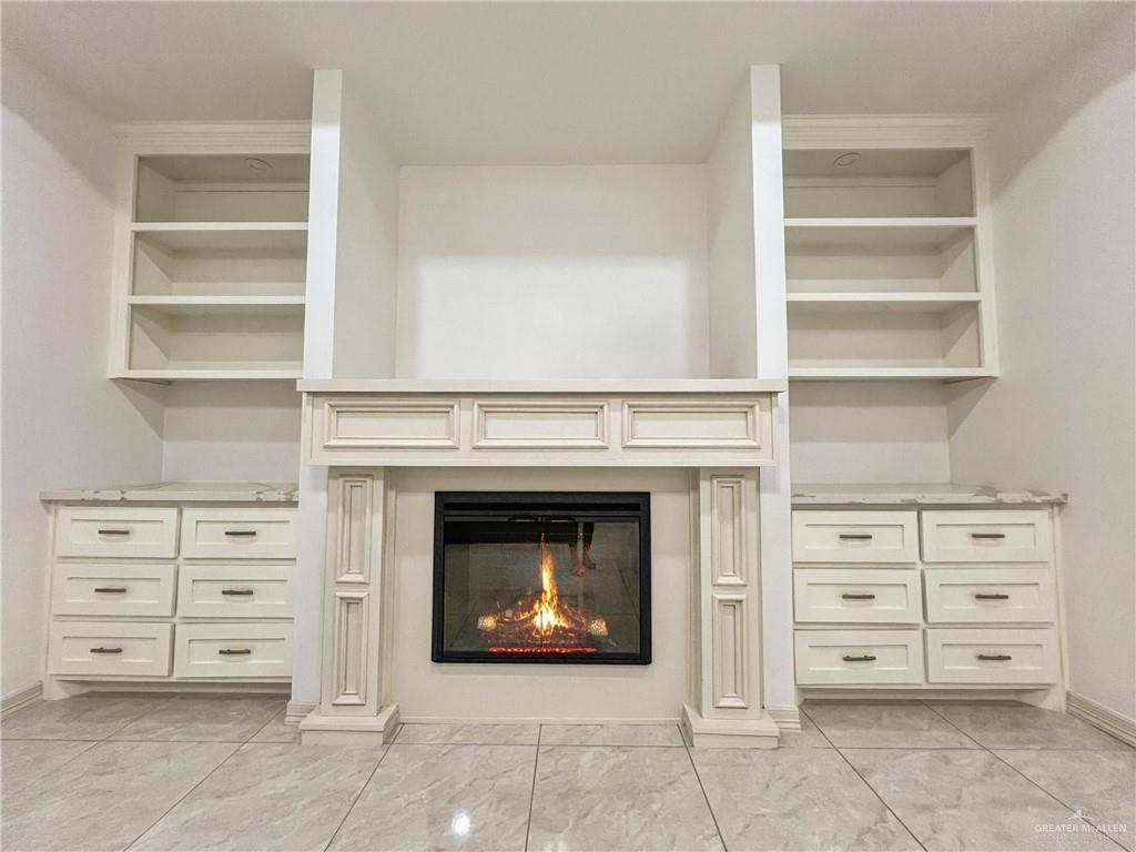 7723 Villa Rama S Street Mission, TX 78572 - Photo 3 of 15 a living room with cabinets and a fireplace