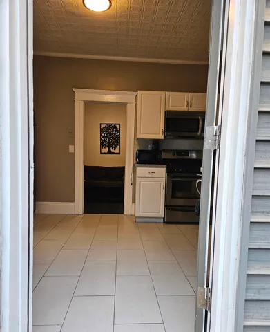 a kitchen with a refrigerator and a stove
